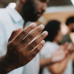 Group of people praying for mental support